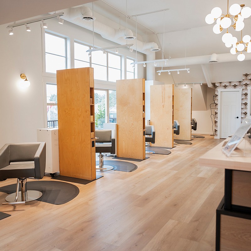 Interior view of Violet Hair Lounge with sunshine coming through the large front windows
