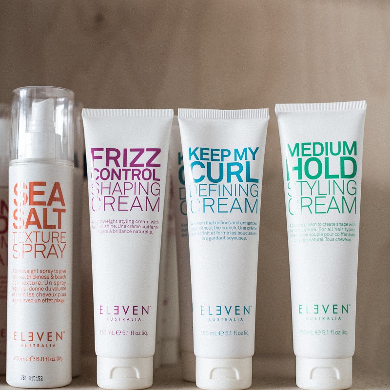 Various Eleven Australia haircare products arranged on a shelf